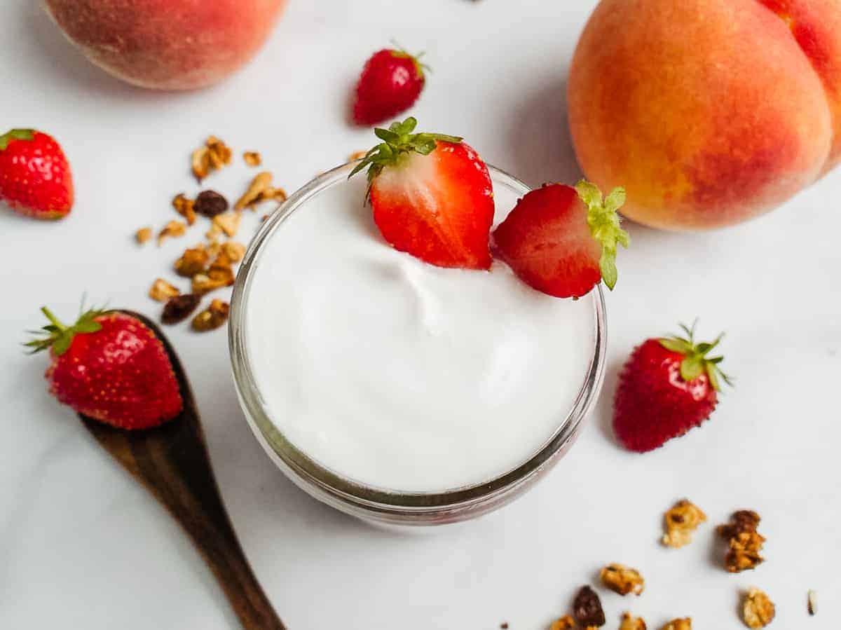 Coconut yogurt and fruit in a jar.