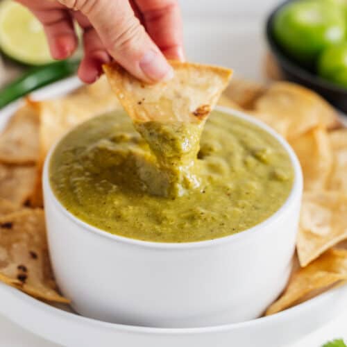 Hand Dipping Chip in Salsa Verde