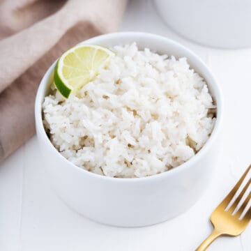 Bowl of White Rice With a Lime Wedge