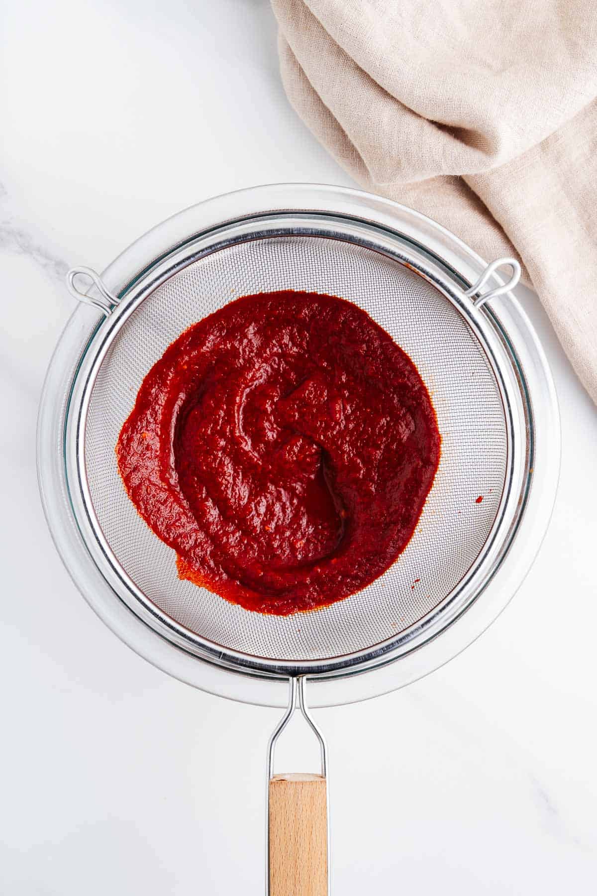 Salsa being strained in