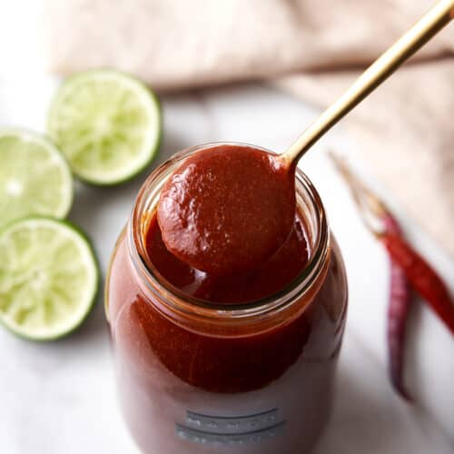 Spoonful of Mango Chamoy Coming Out of a Jar