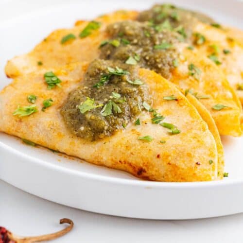 Tacos de canasta on a plate.