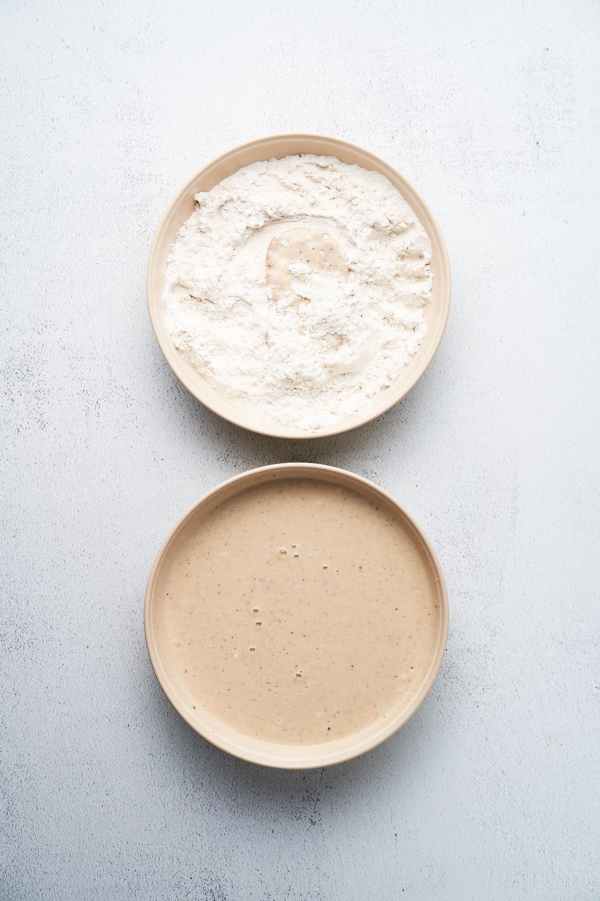 Dredging seitan through flour and batter.