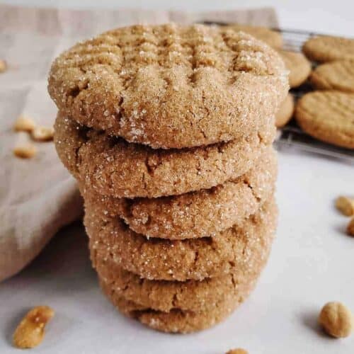 Vegan peanut butter cookies stacked on top of each other.