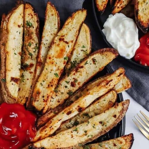 Baked potato wedges on a plate.