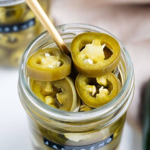 Pickled jalapeños in a jar.