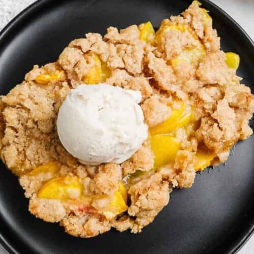 Vegan peach cobbler on a plate.