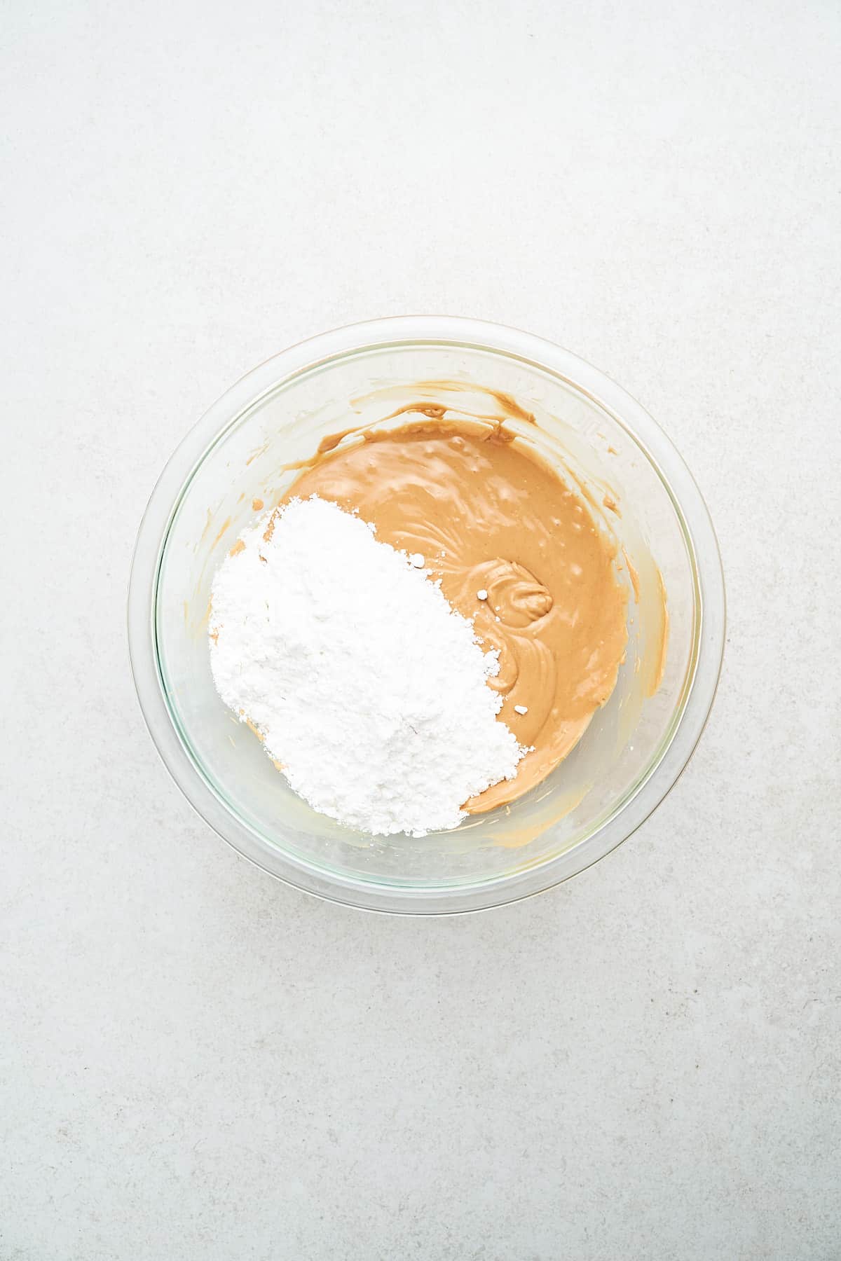 Powdered sugar and peanut butter in a bowl.