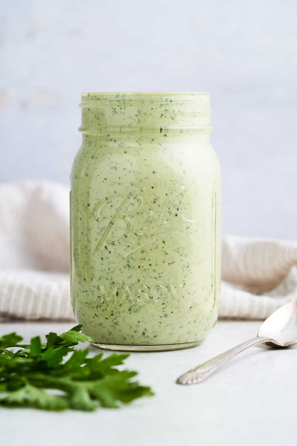 Lemon herb tahini in a mason jar.