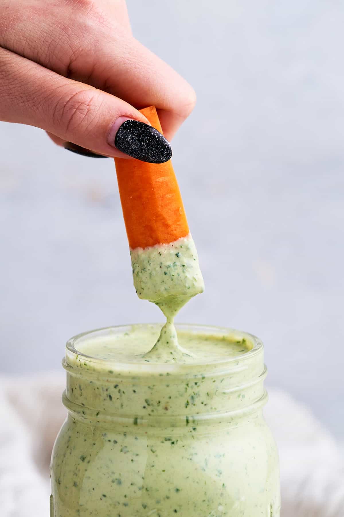 Carrot dipped in lemon herb tahini.