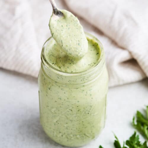 Lemon herb tahini on a spoon.