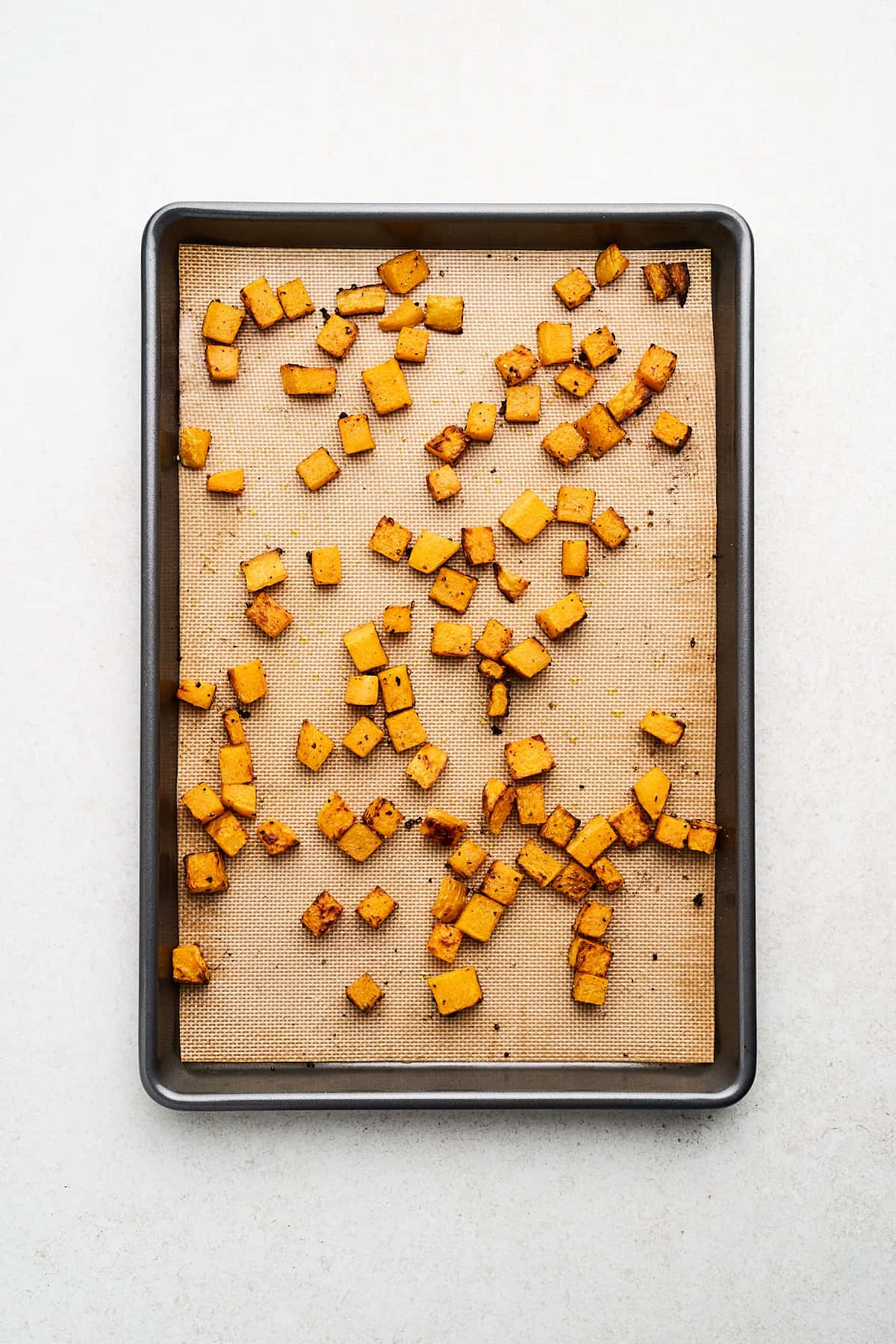 Roasted butternut squash on a pan.