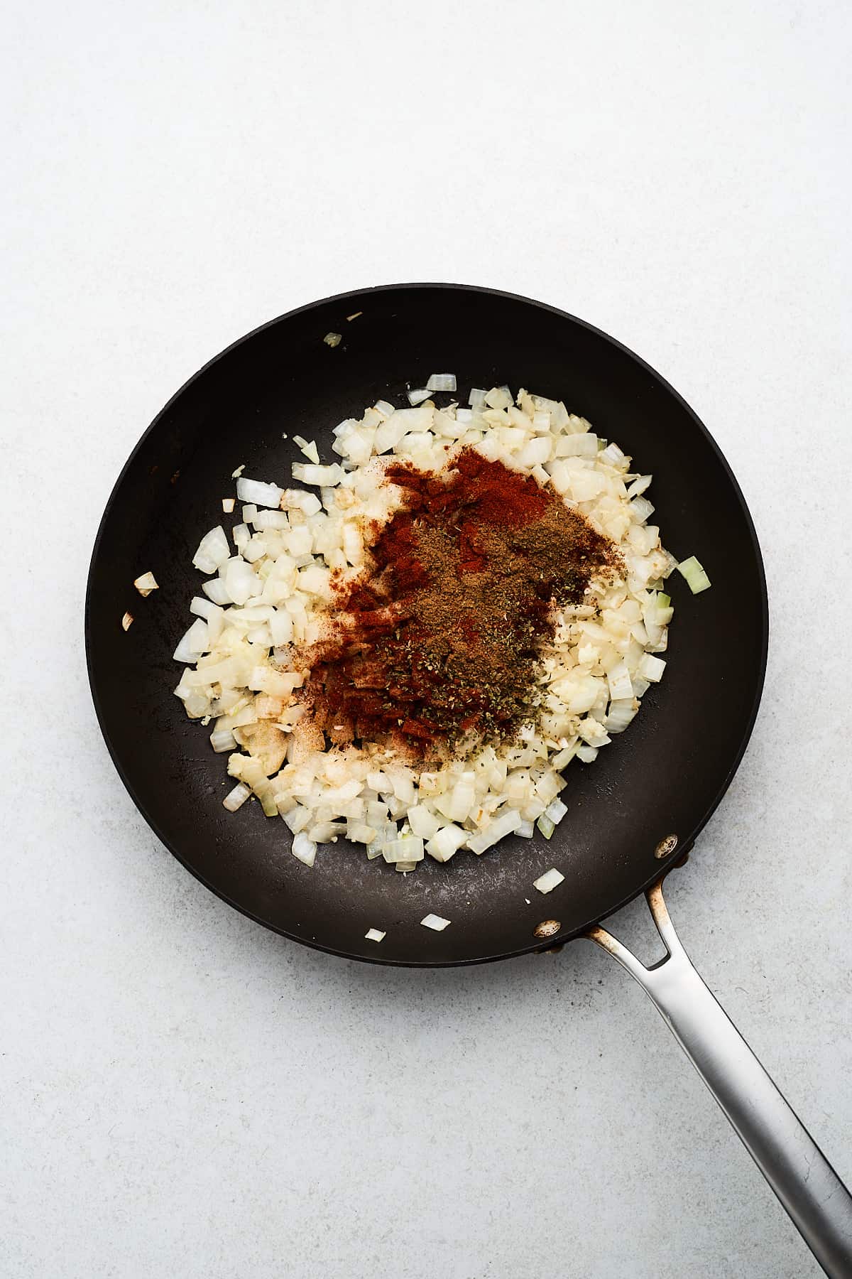 Onions, garlic, and spices in a pan.