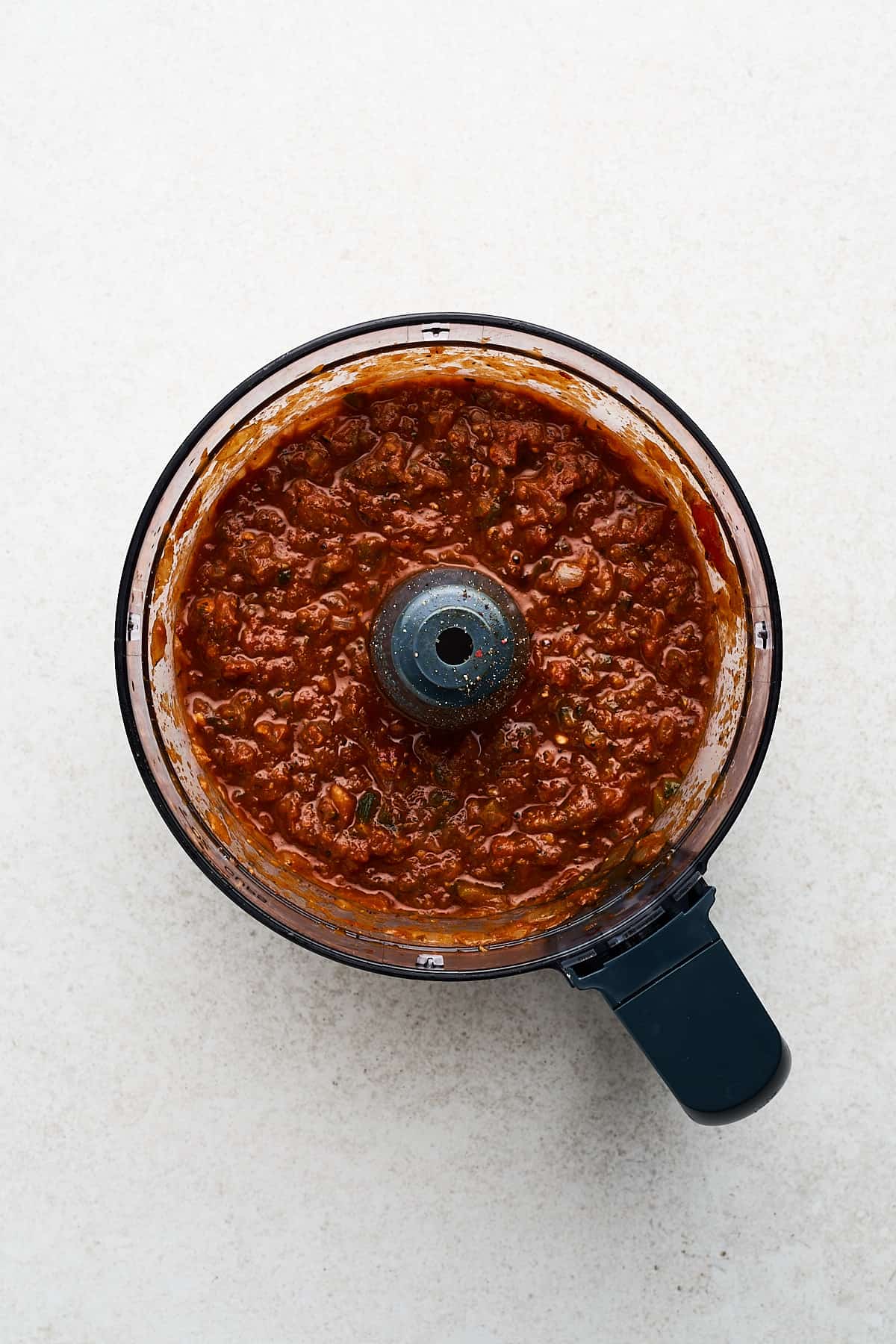 Red salsa in a food processor.