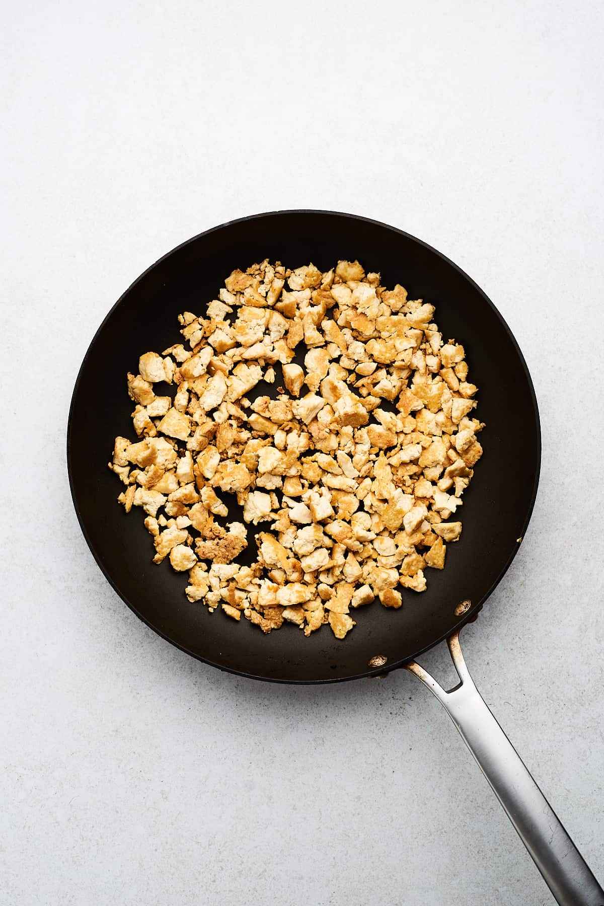 Browned tofu in a pan.