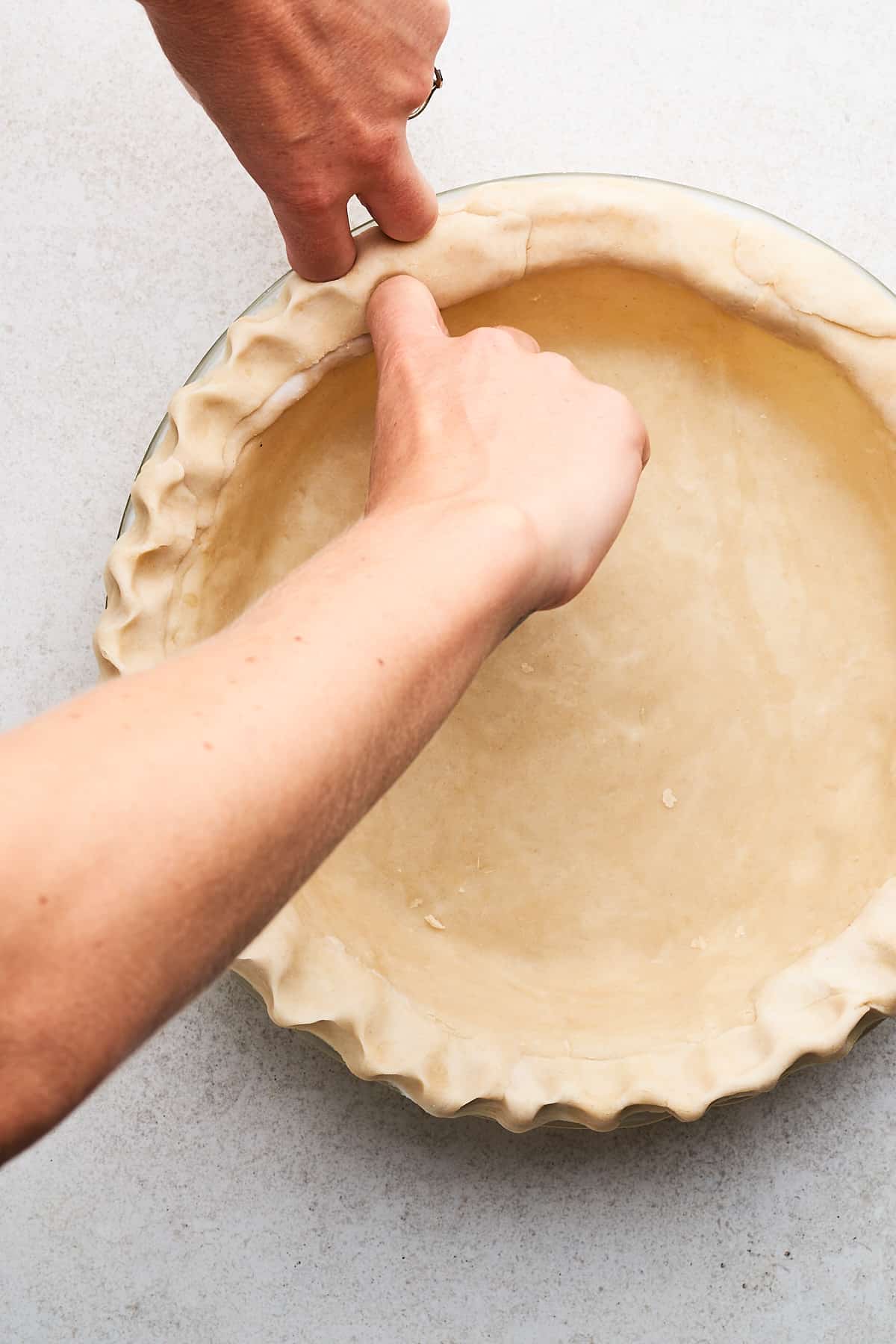 Crimping vegan pie crust.