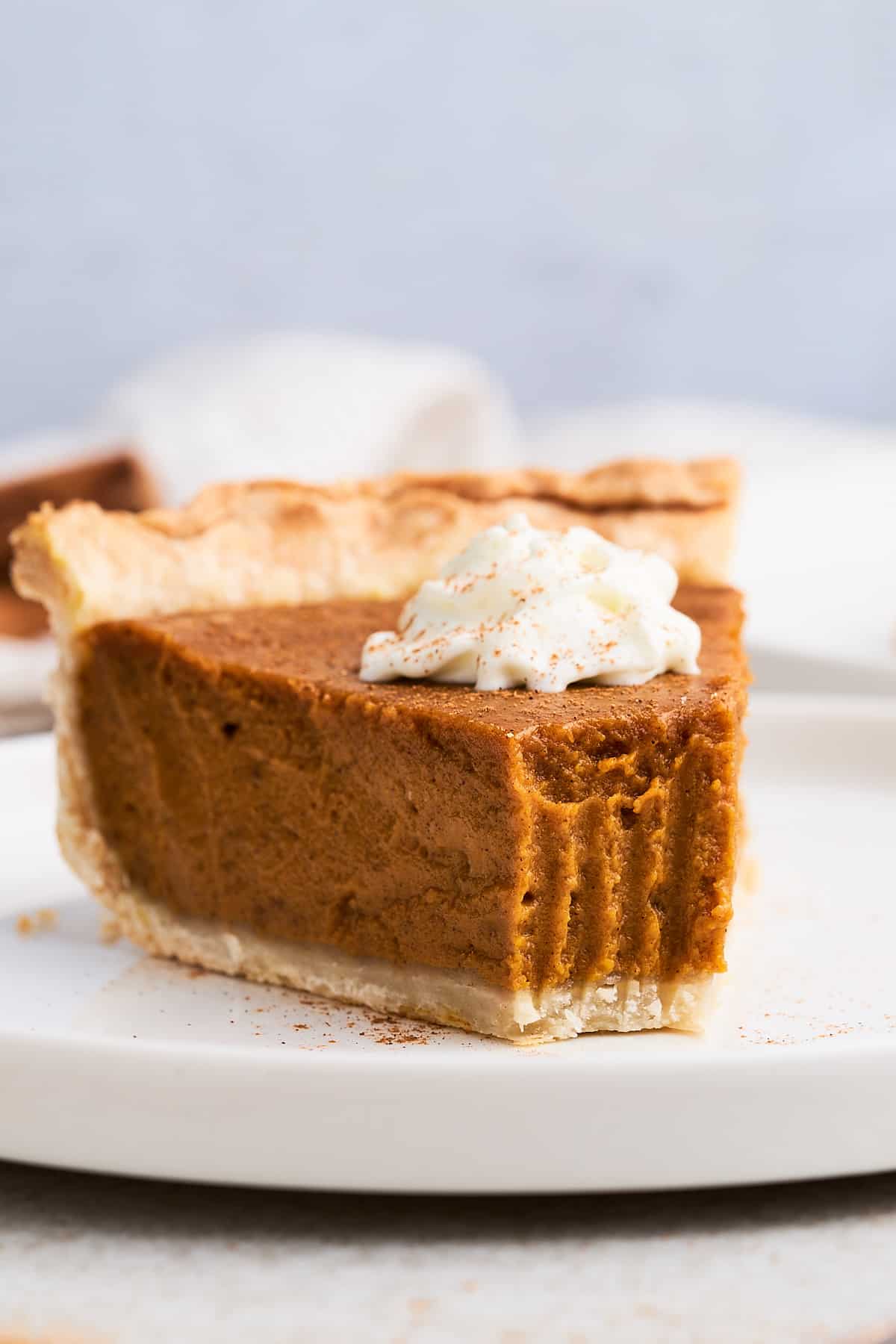 Bite taken out of vegan pumpkin pie slice.