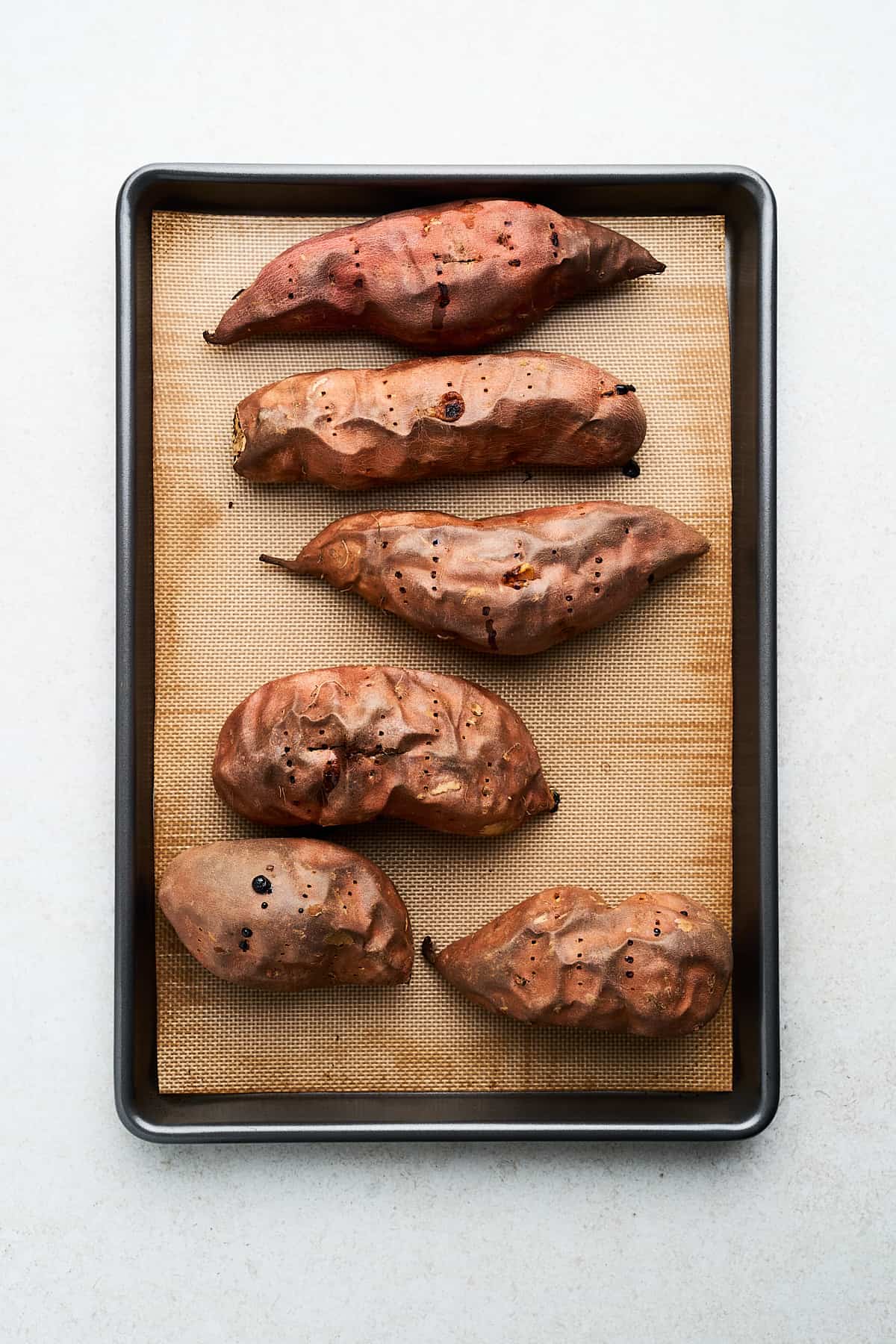 Cooked sweet potatoes on a pan.