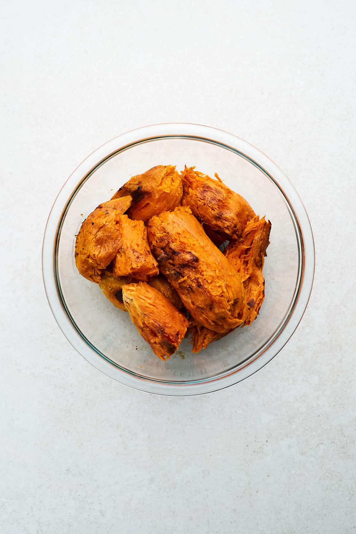 Peeled sweet potatoes in a bowl.