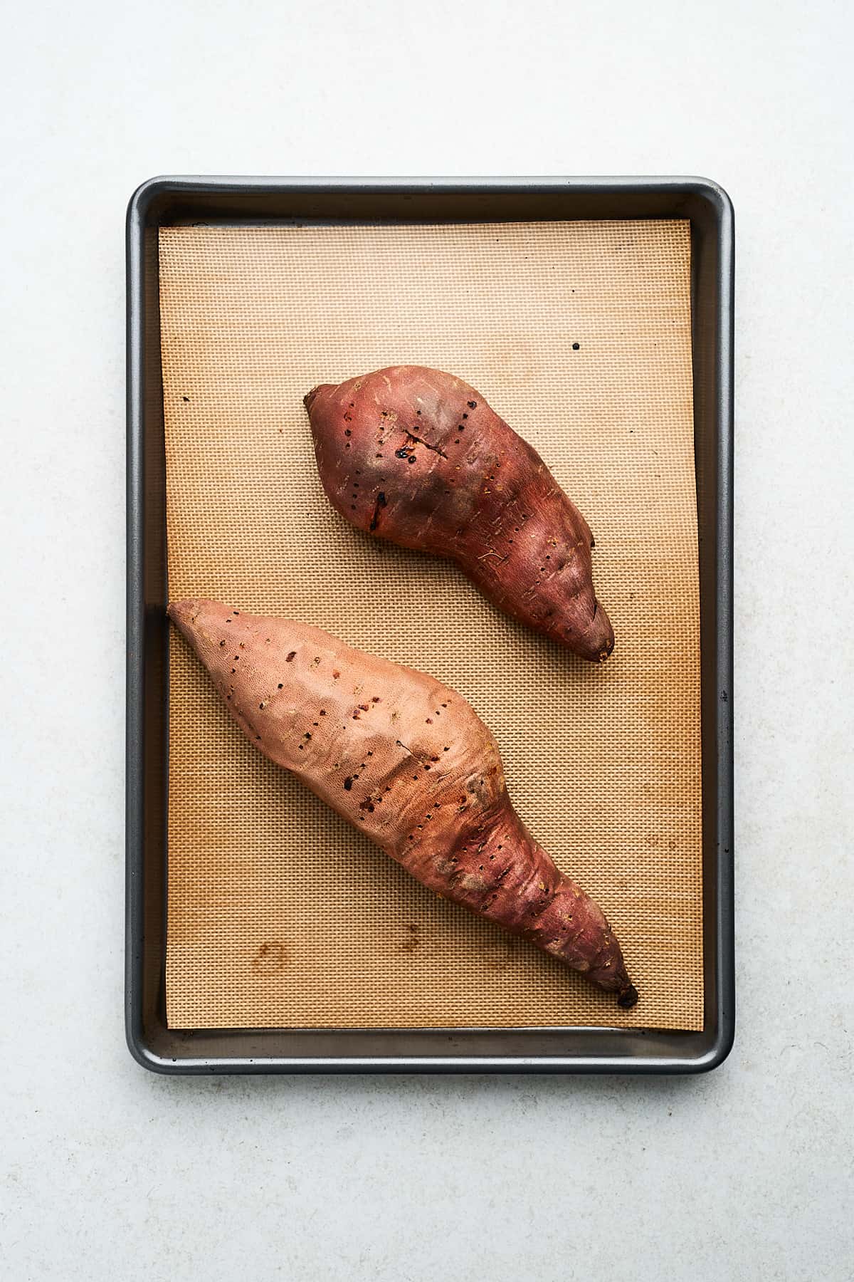 Roasted sweet potatoes on a pan.