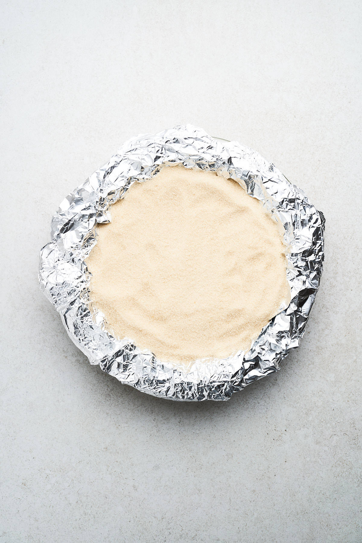 Sugar and tin foil on a vegan pie crust.