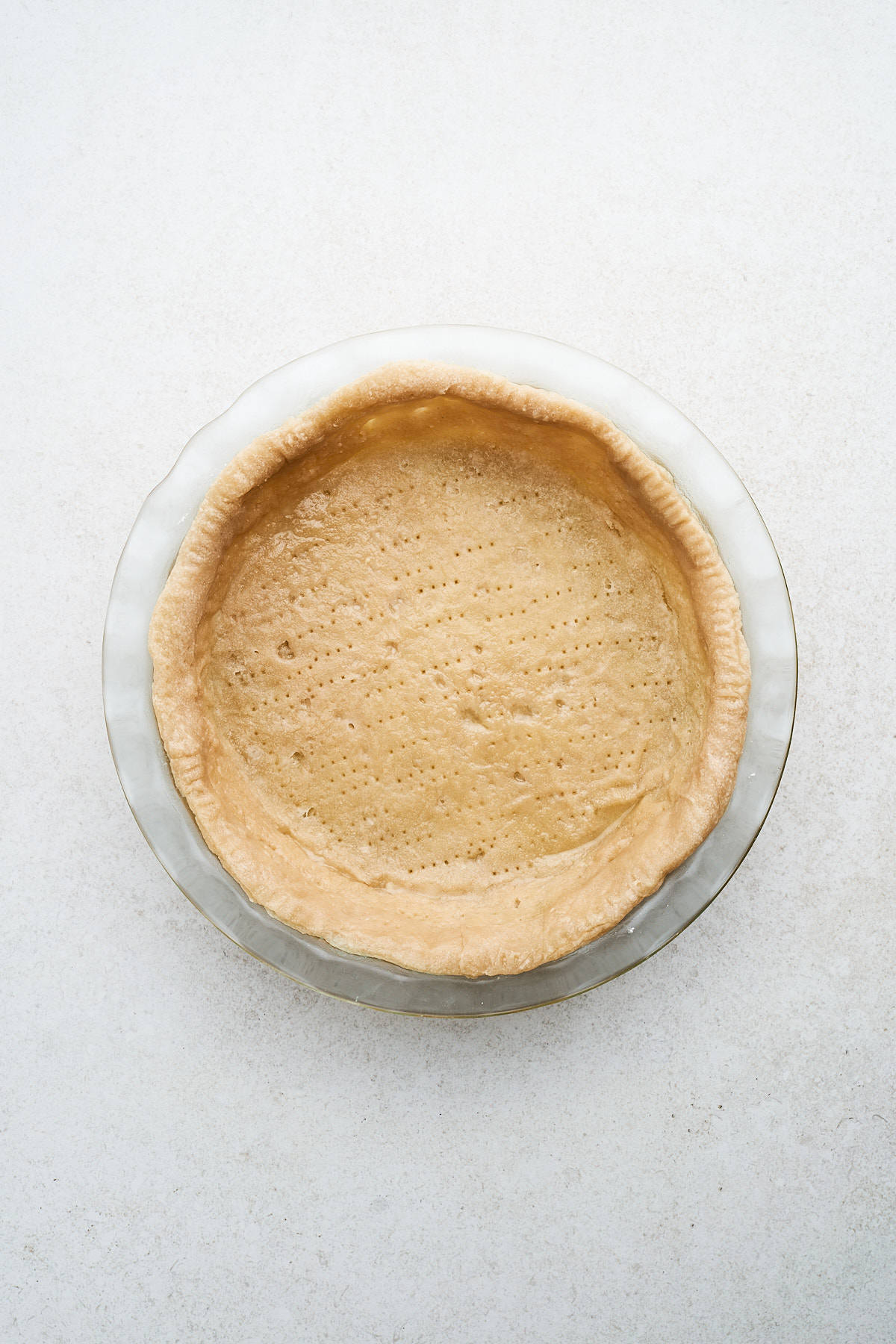 Baked vegan pie crust in a pan.