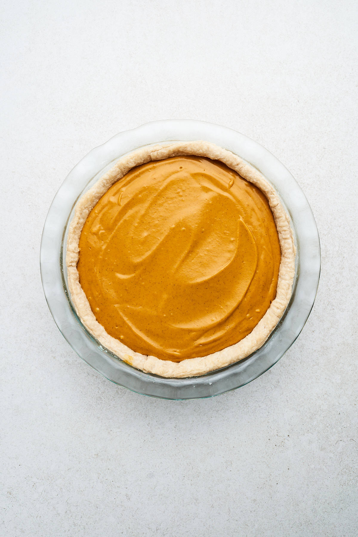 Uncooked vegan sweet potato pie in a pan.