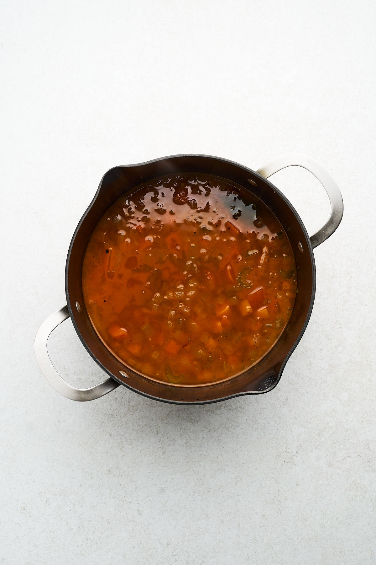 Unblended vegan sweet potato soup in a pot.