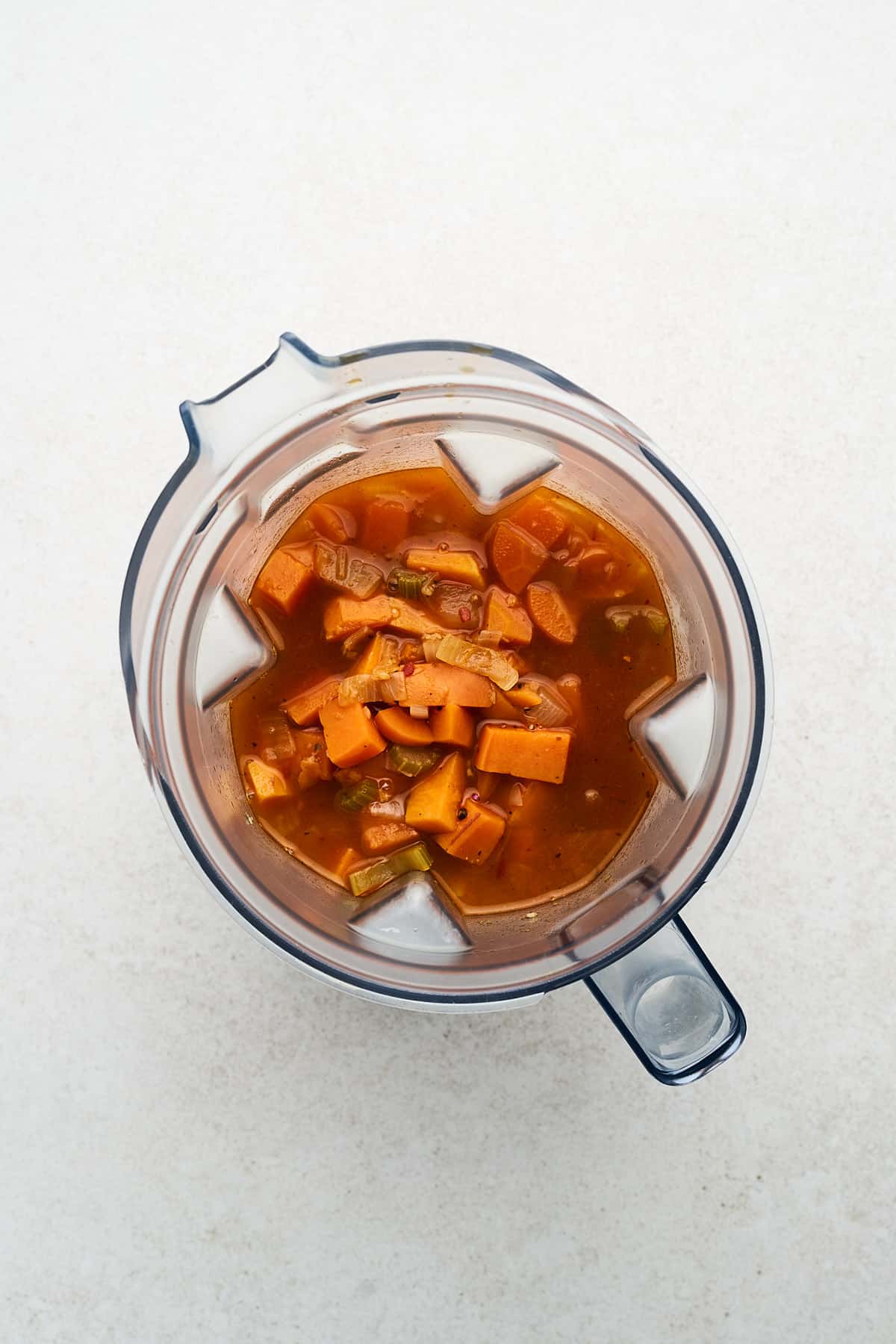 Unblended vegan sweet potato soup in a blender.