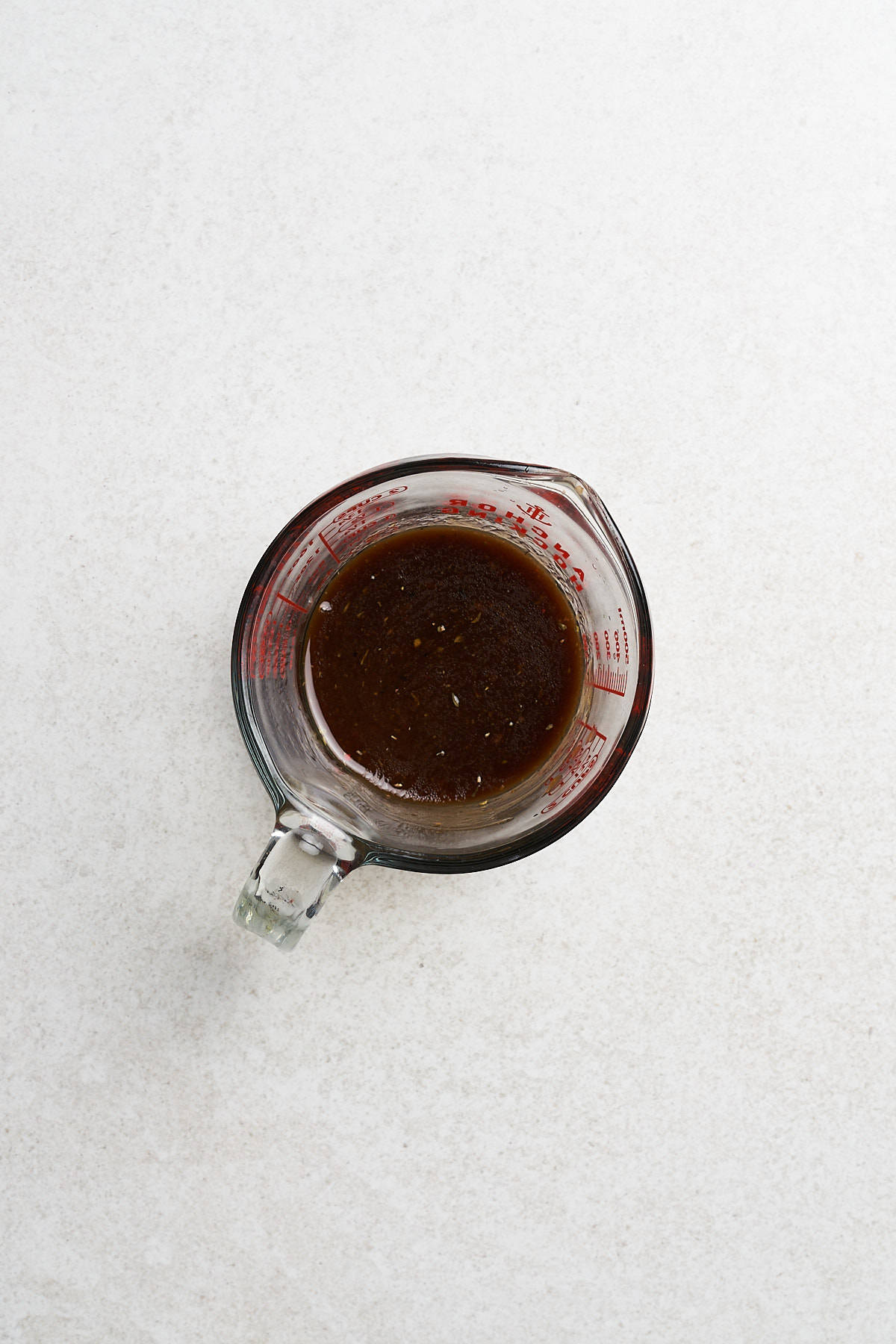 Balsamic dressing in a glass container.