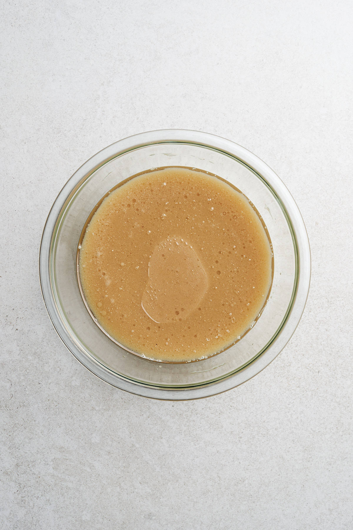 Wet cake ingredients combined in a bowl.