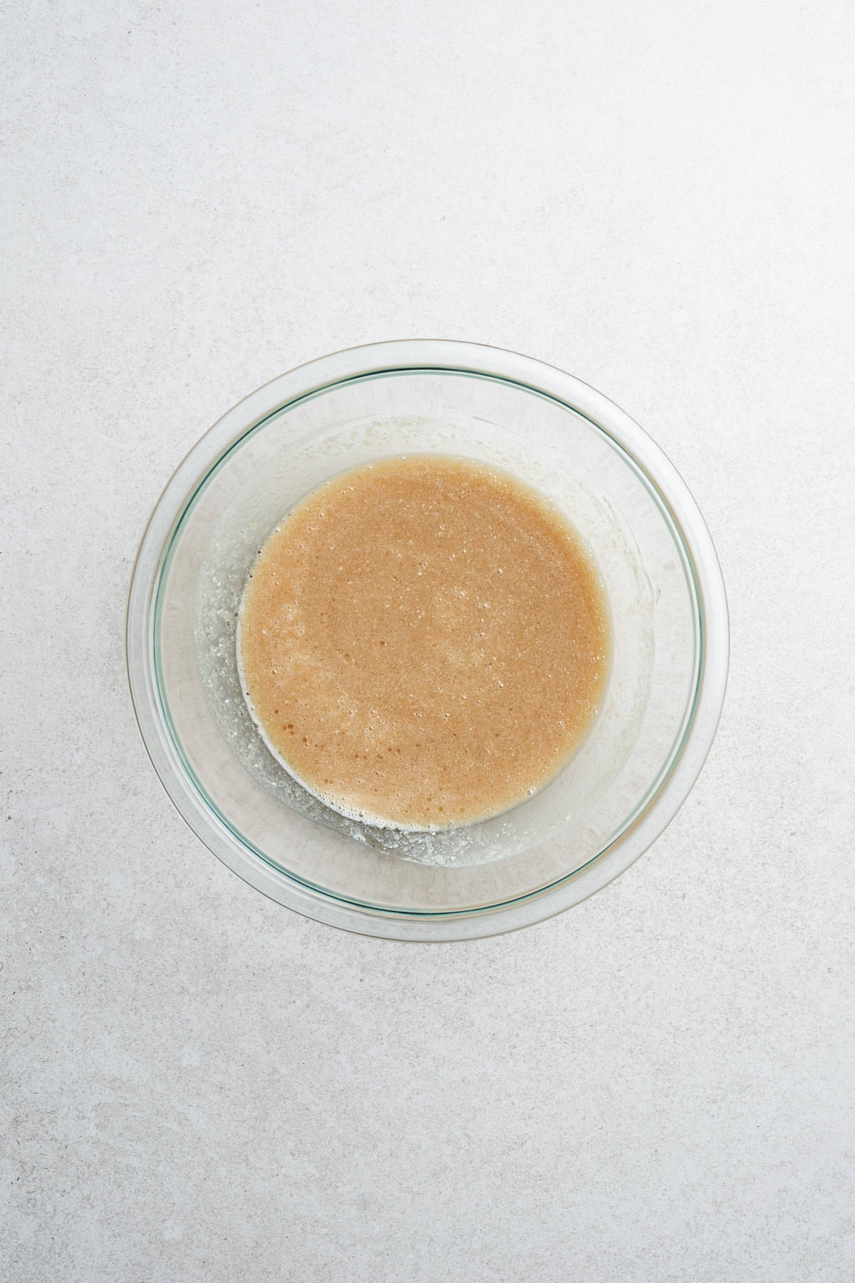 Mixed wet ingredients for vegan apple cider donuts in a bowl.