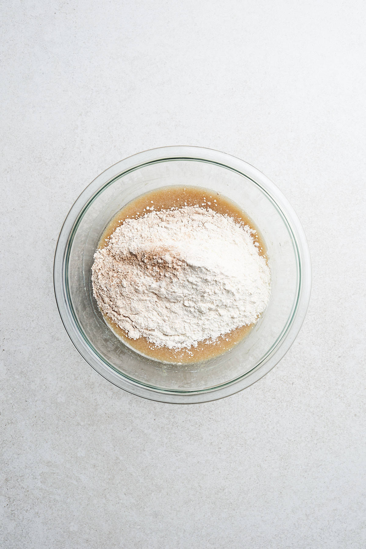Ingredients for vegan apple cider donuts in a bowl.