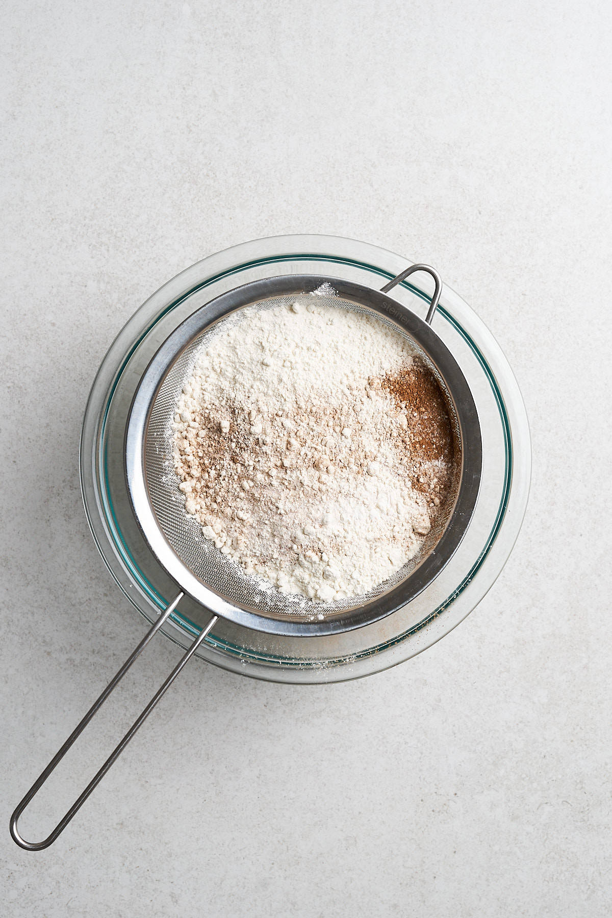 Dry ingredients sifting into a bowl.