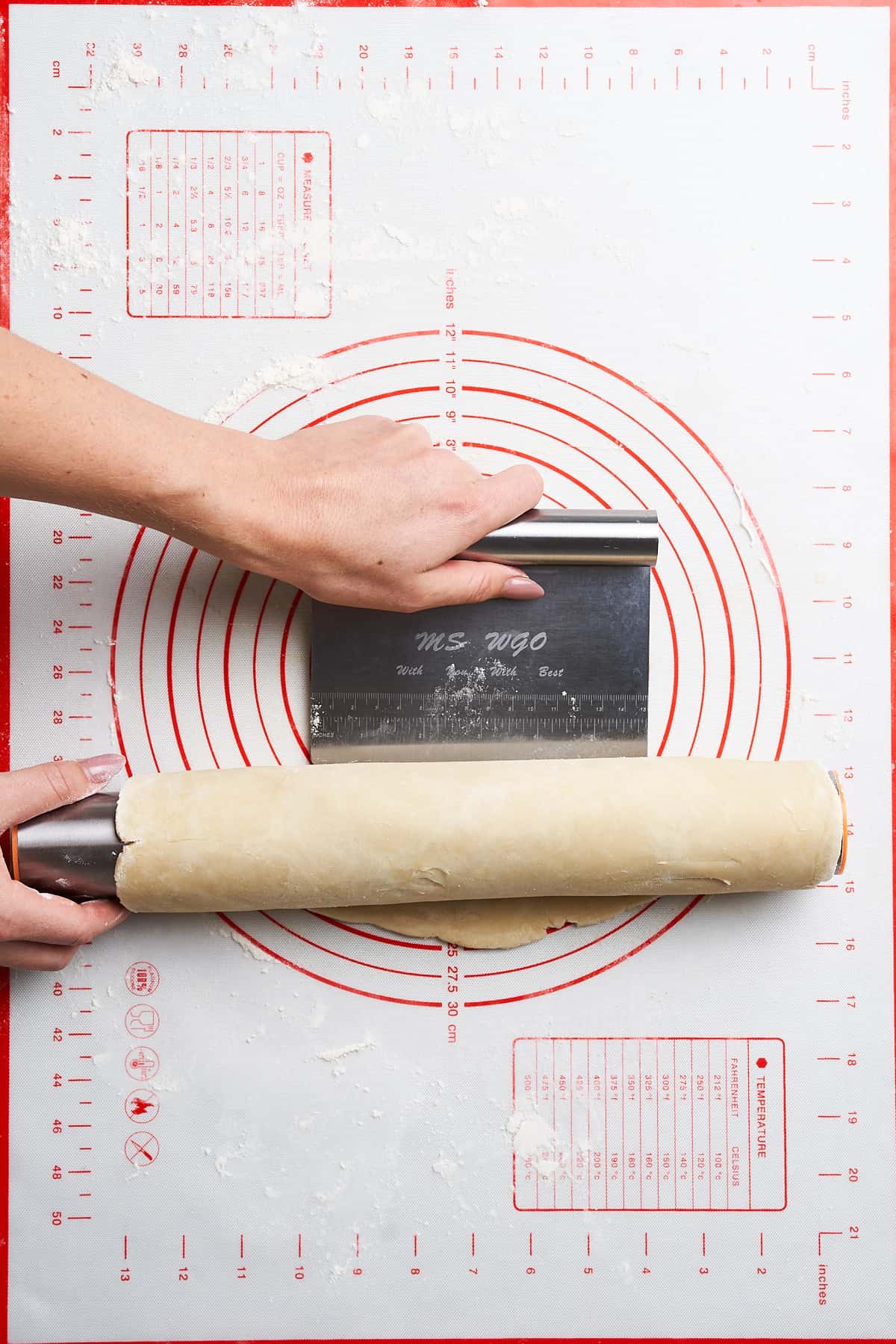 Transferring pie dough on a rolling pin.