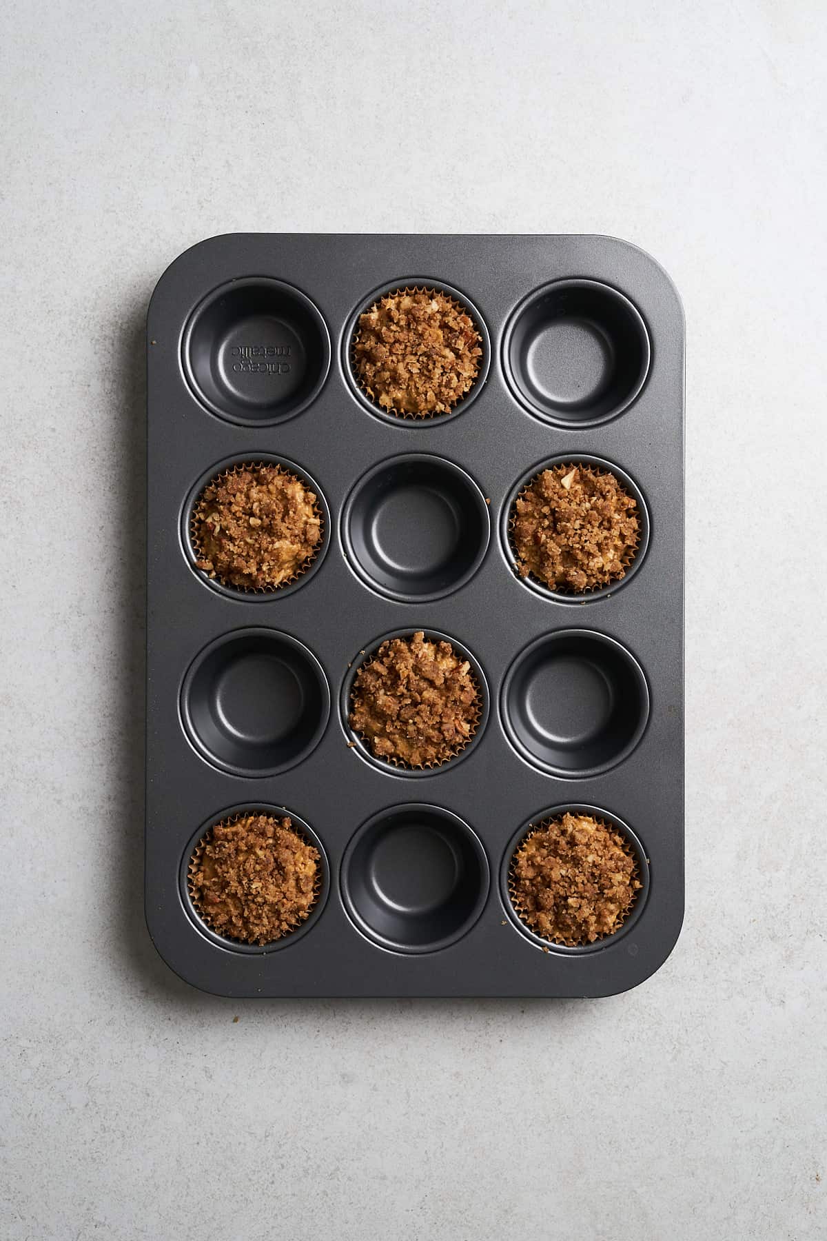 Streusel on top of muffin batter.