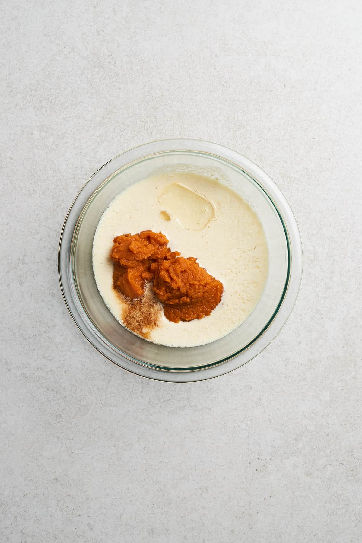 Vegan buttermilk, pumpkin puree, and oil in a bowl.