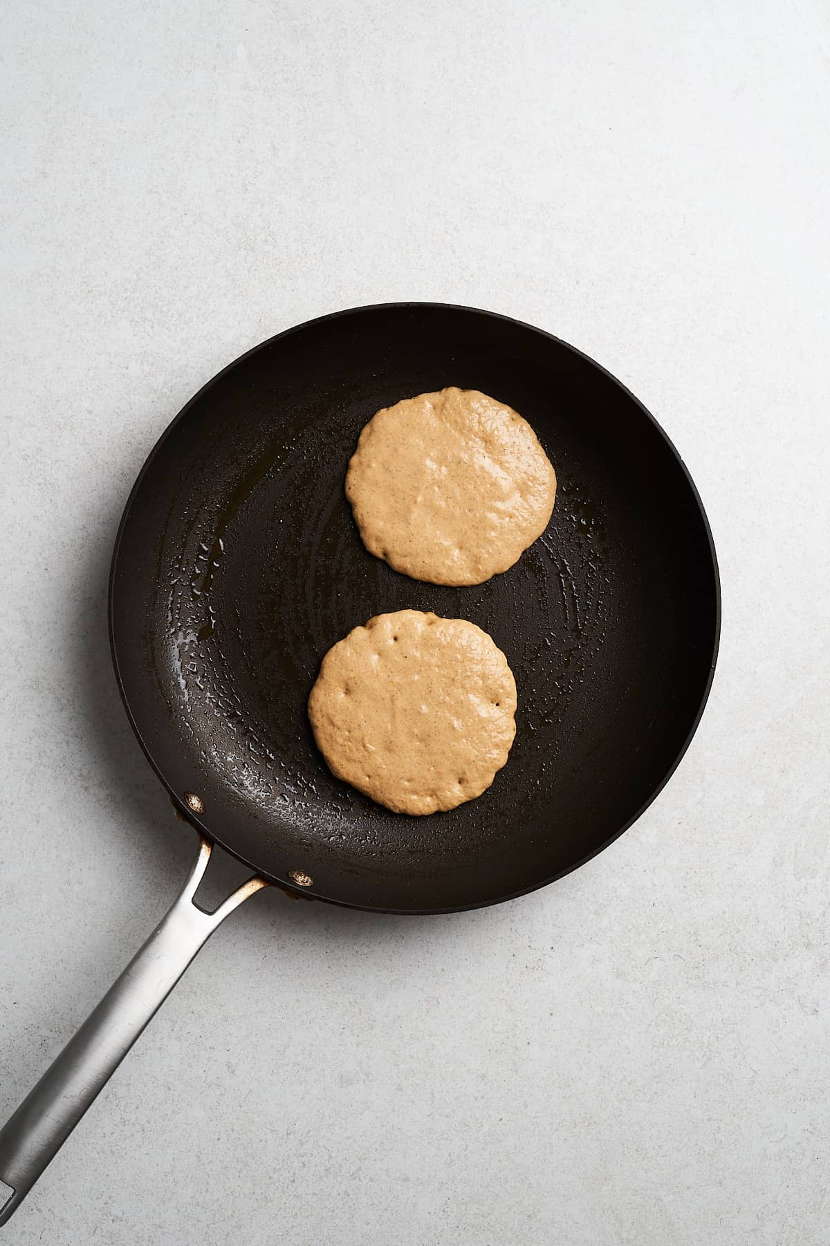 Cooking pancakes in a hot pan.