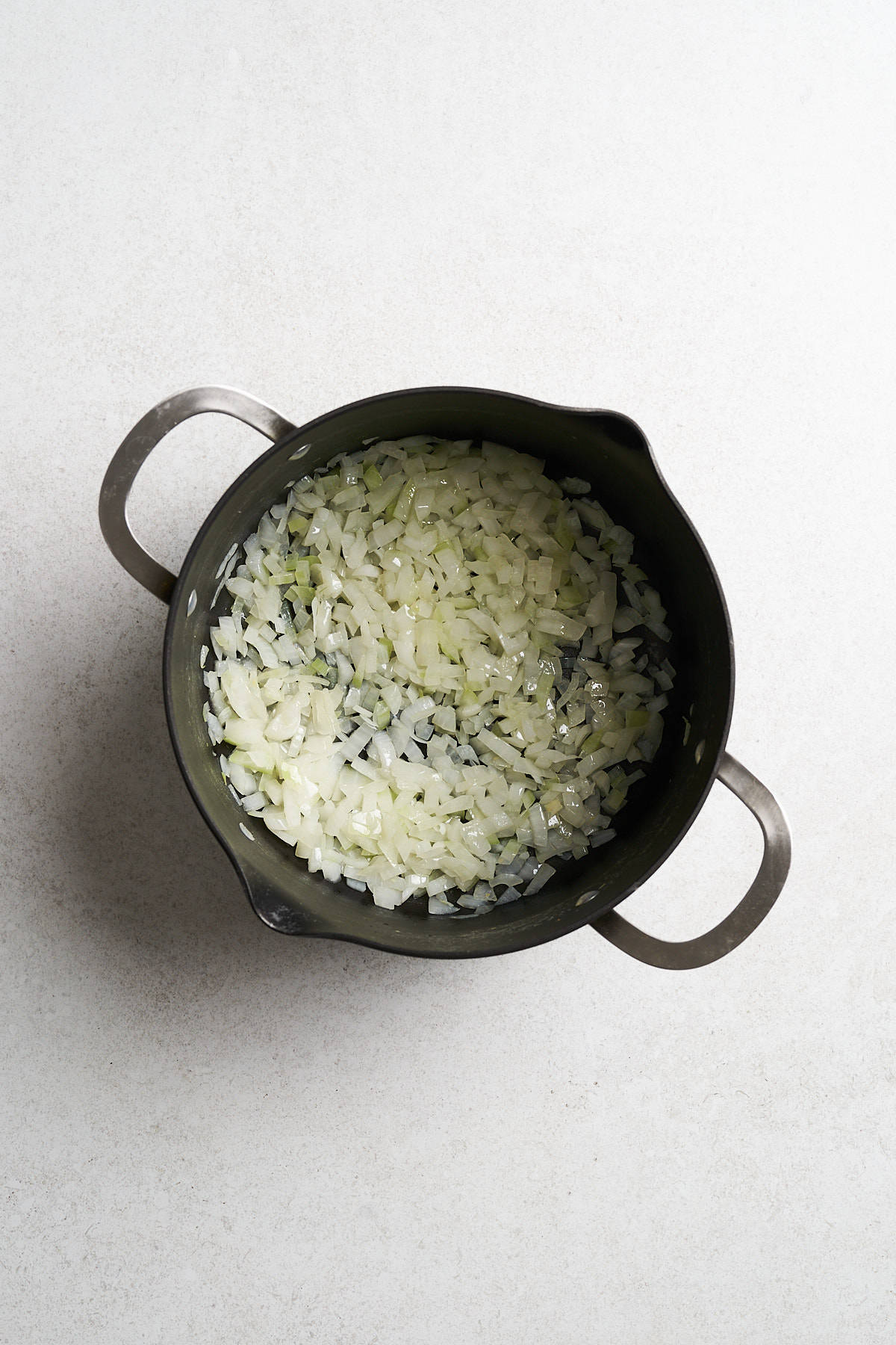 Sautรฉed onions in a pot.