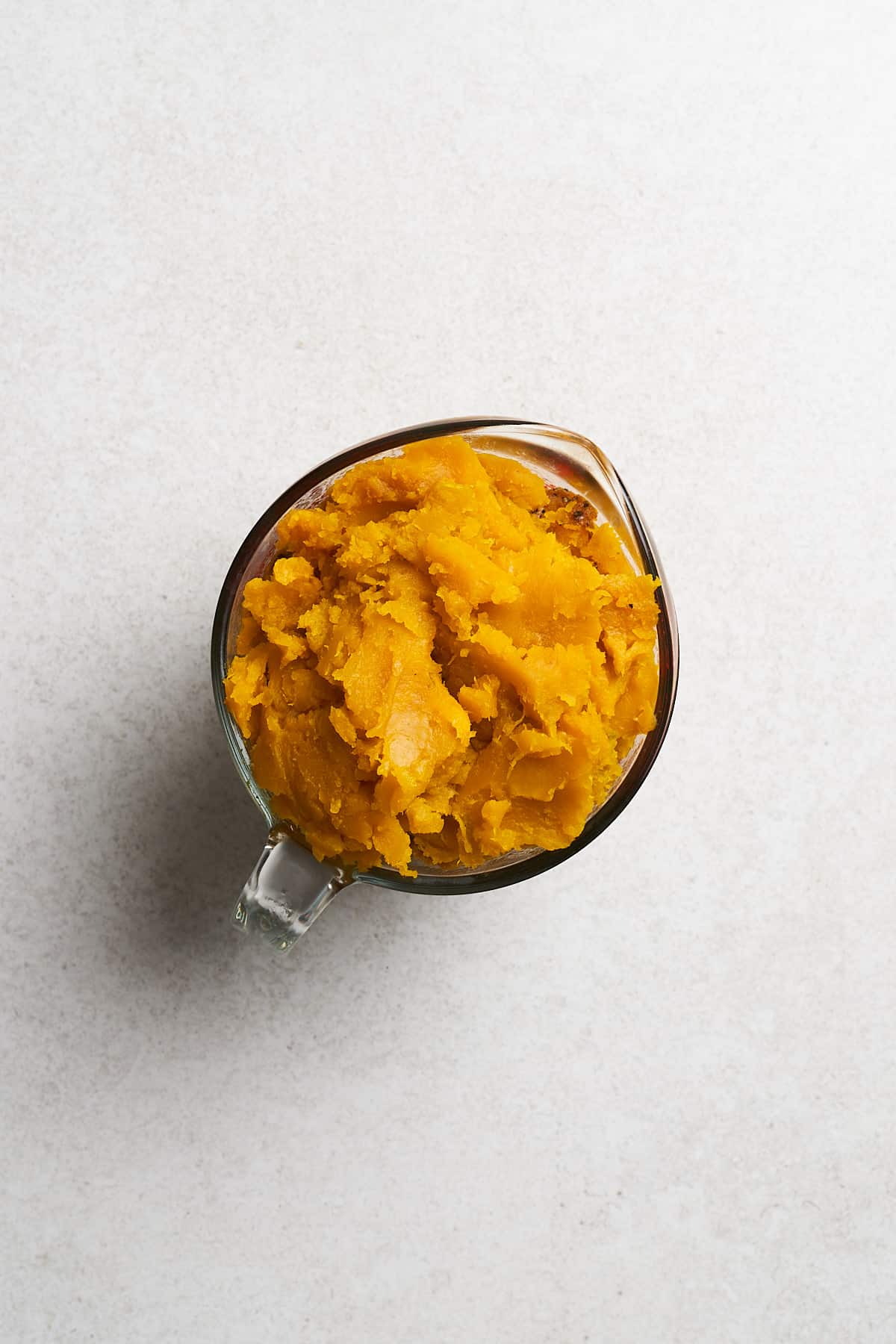 Roasted squash in a measuring cup.