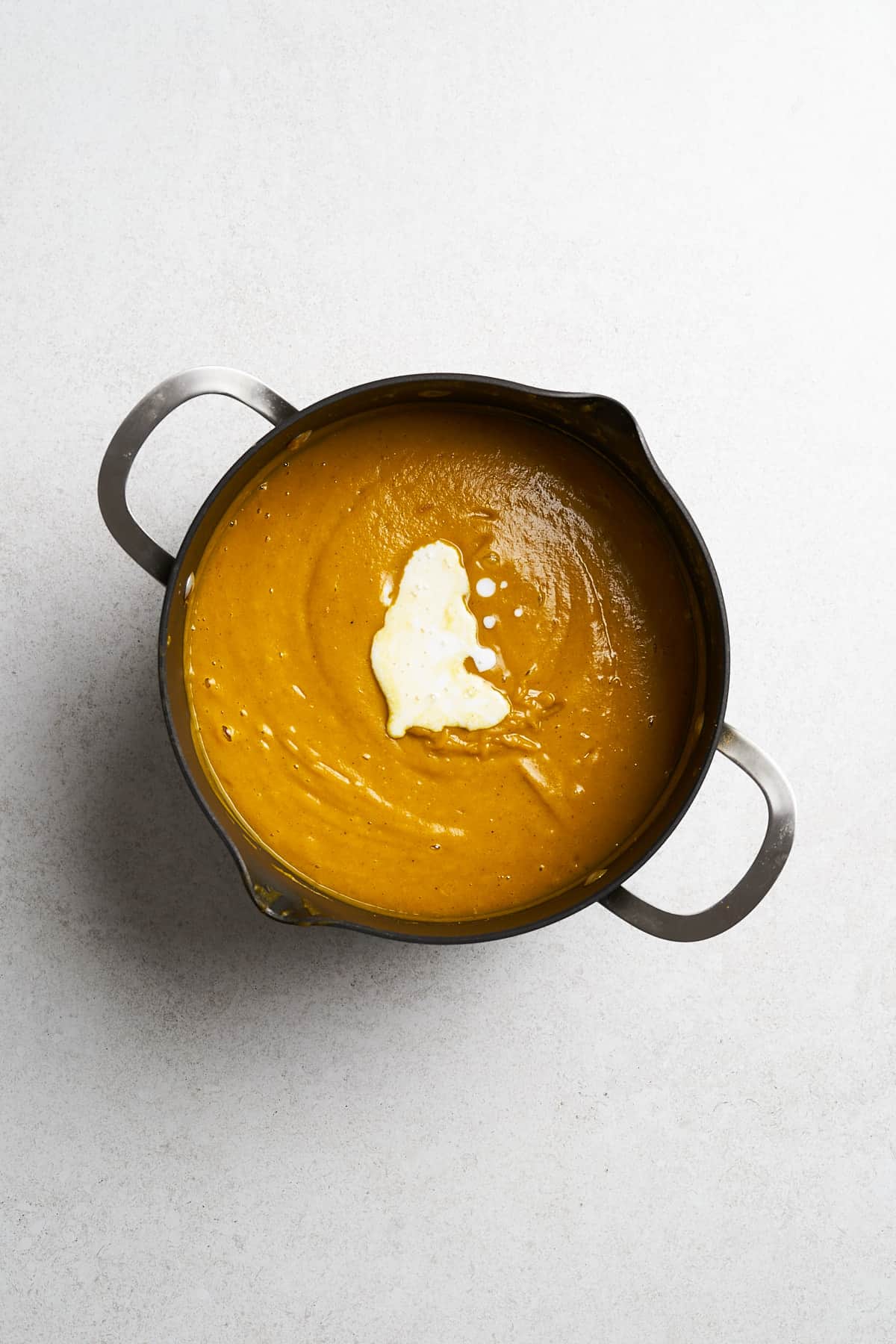 Coconut milk in vegan pumpkin soup.