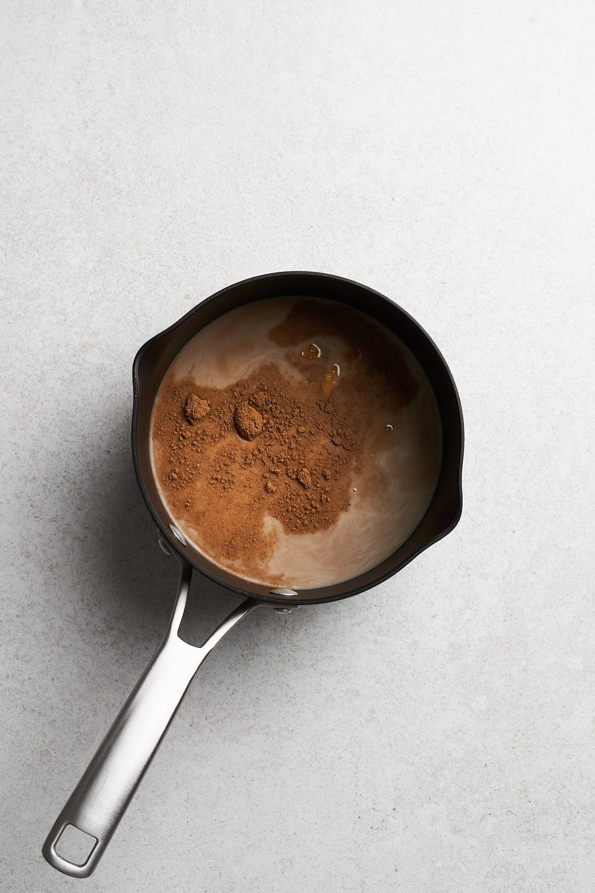 Spices and milk in a saucepan.