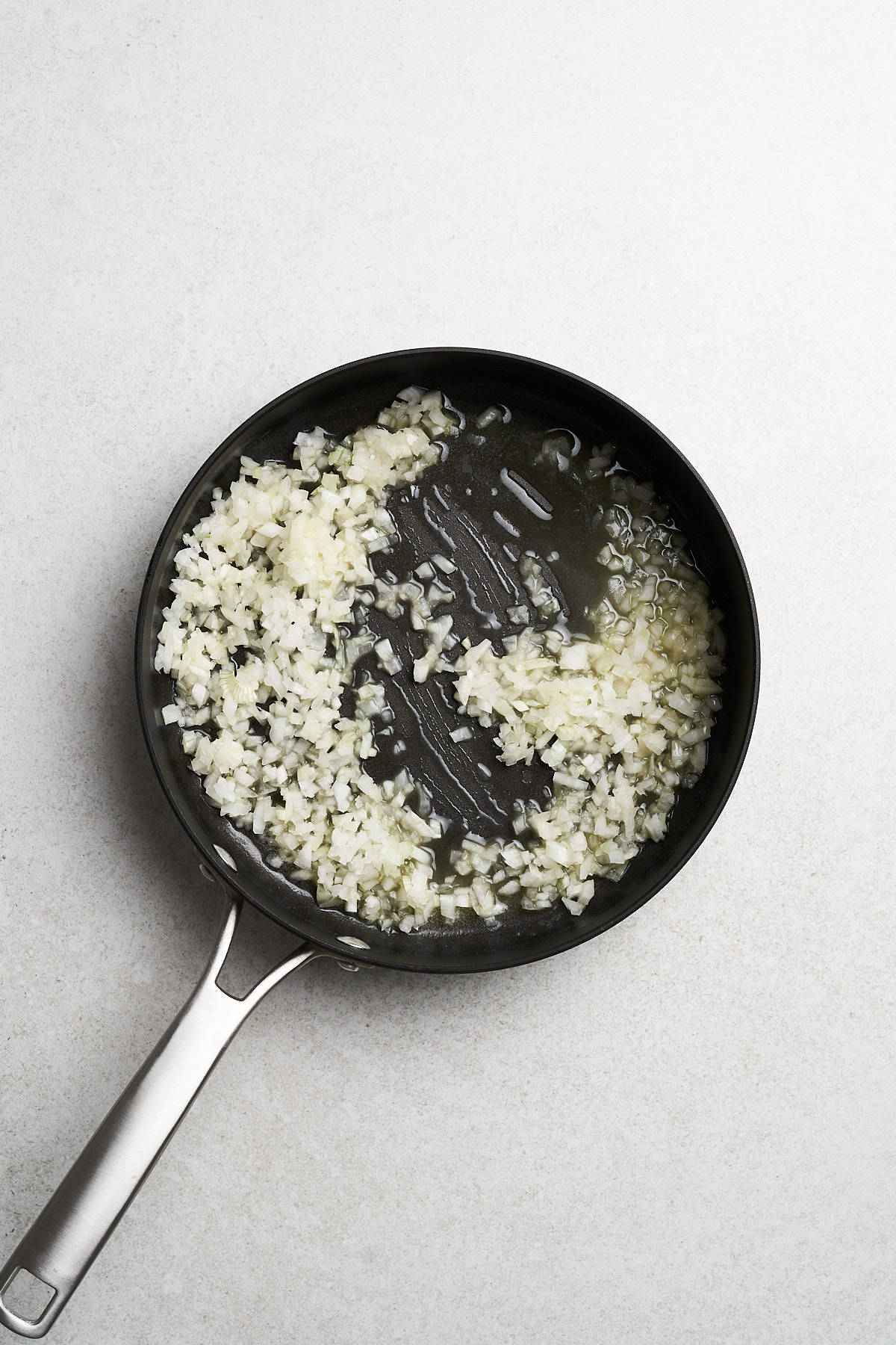 Onions sautéing in vegan butter.