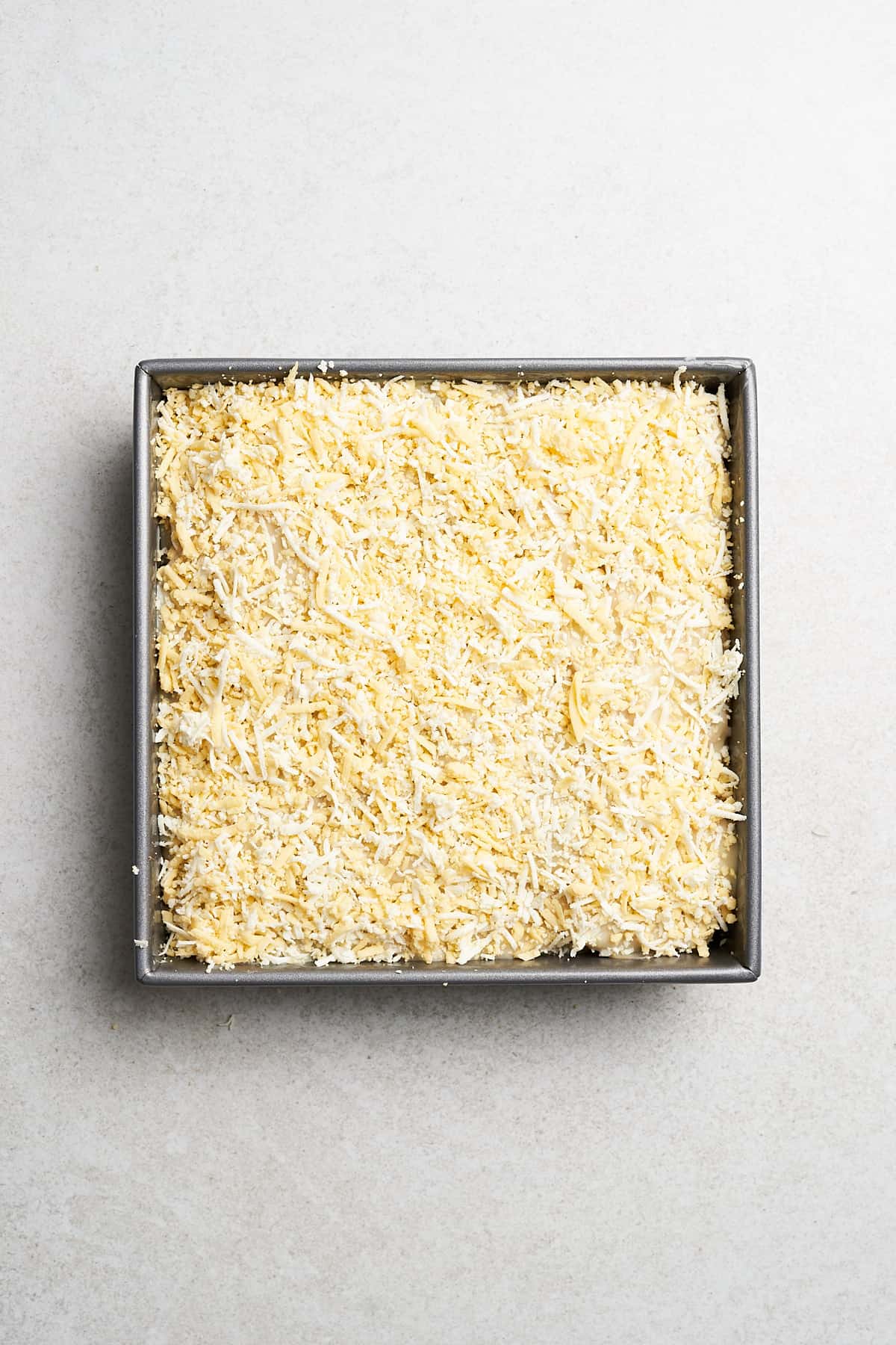 Shredded vegan cheese on scalloped potatoes.