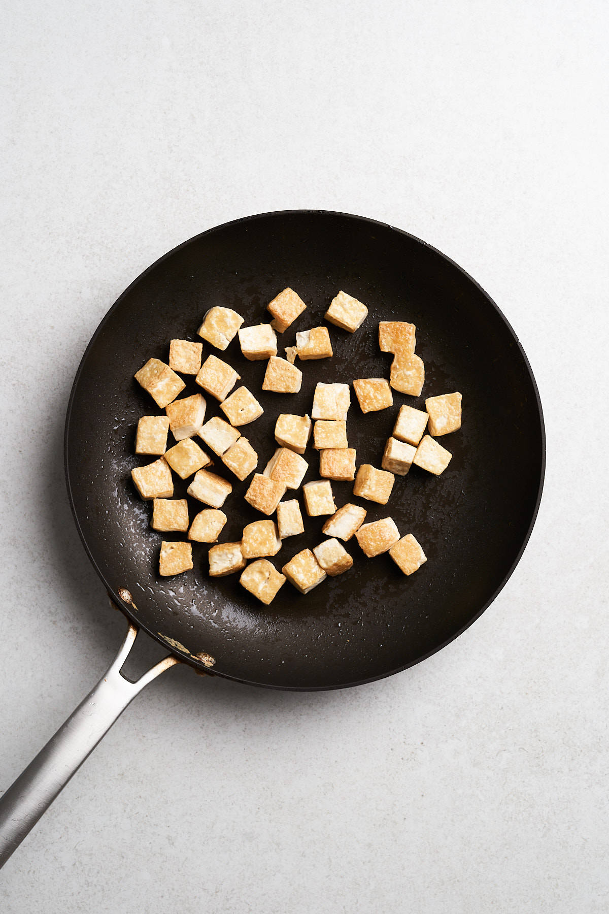 Tofu in a frying pan.
