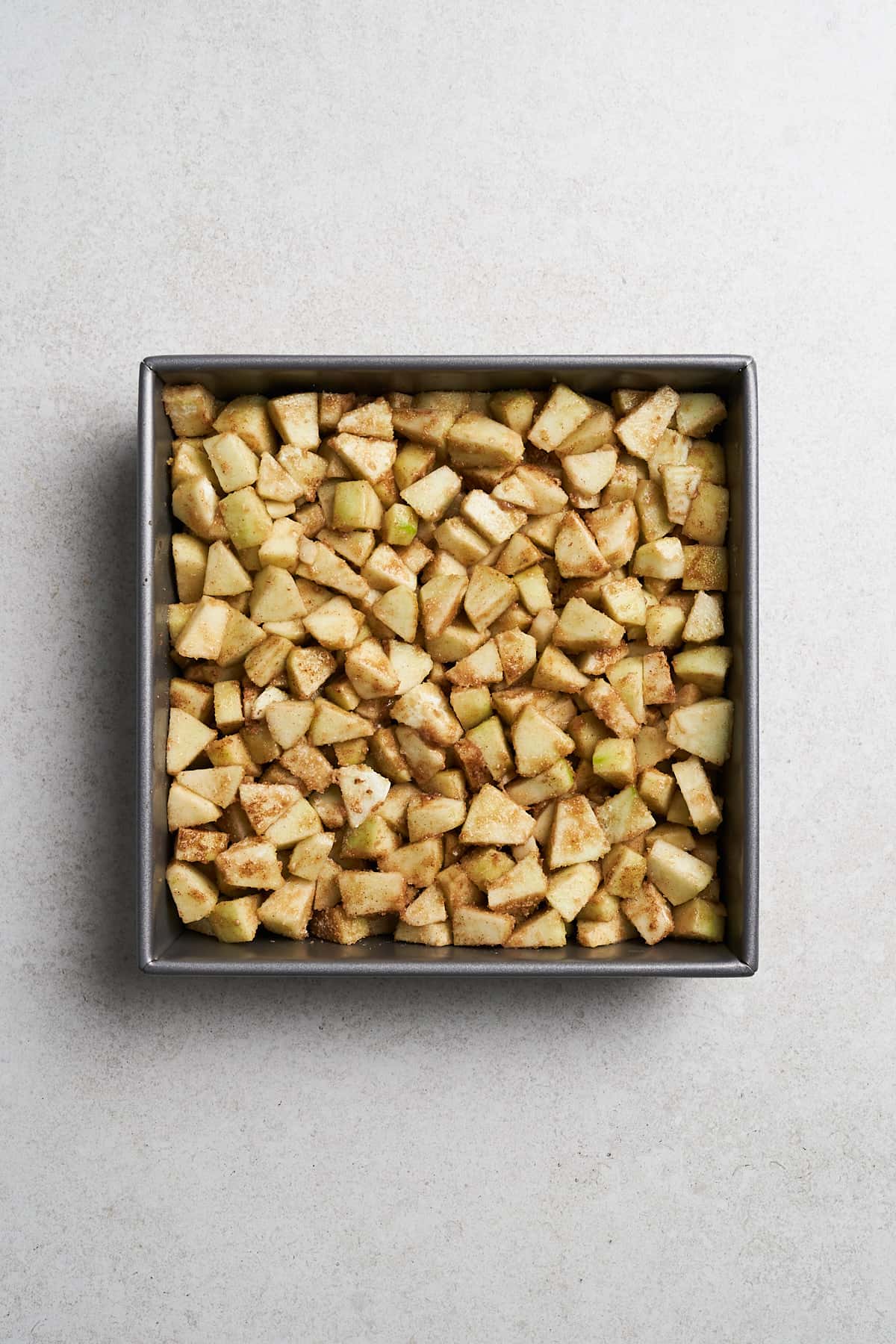 Vegan Apple Crumble with ingredients in a baking sheet.