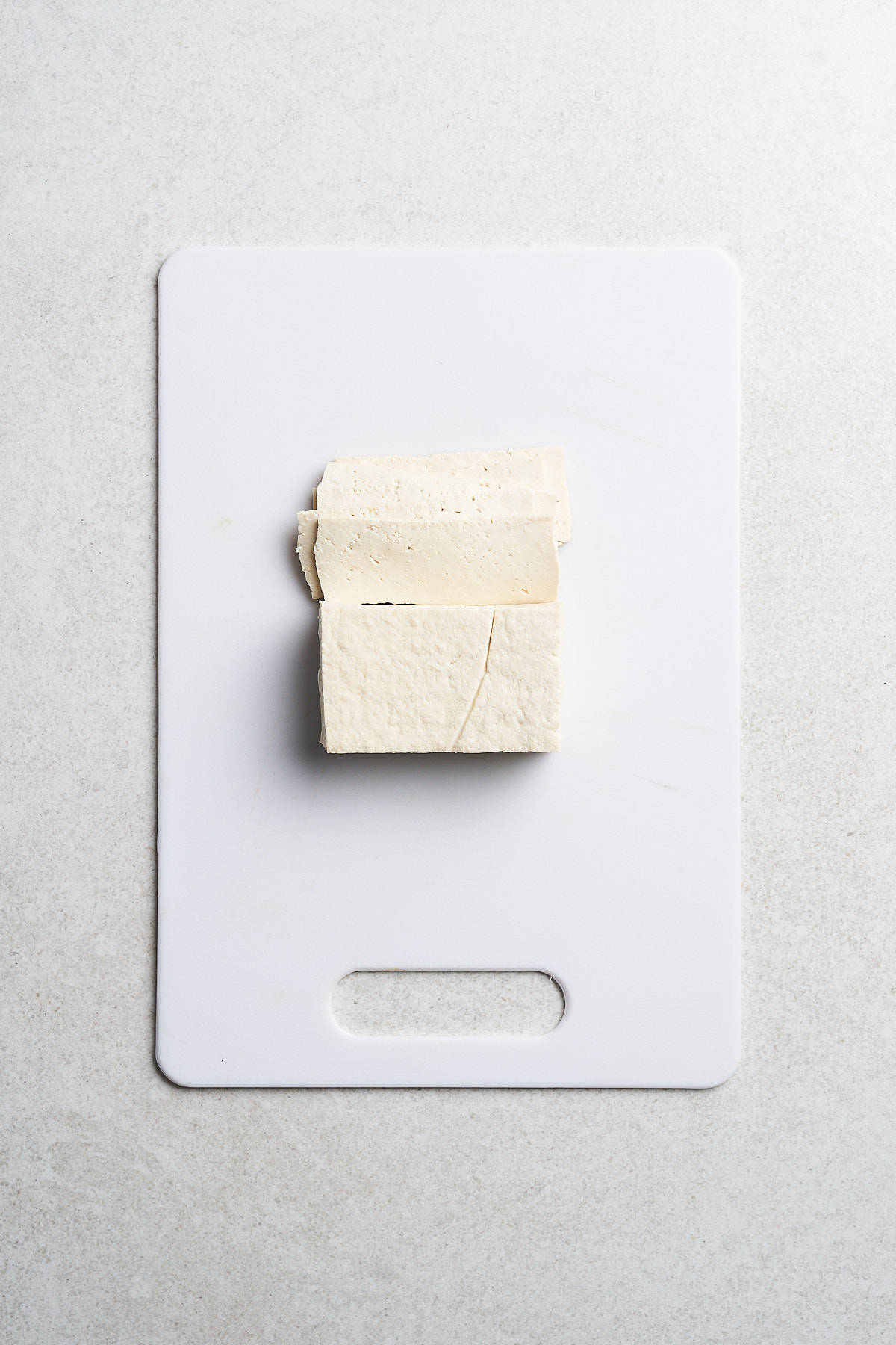 Tofu on a cutting board.