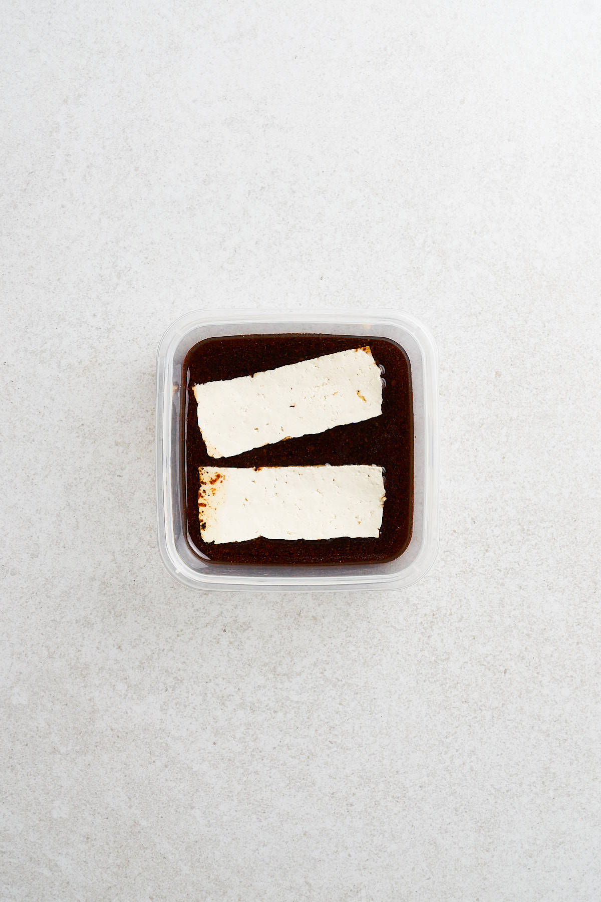 Tofu strips in a container.