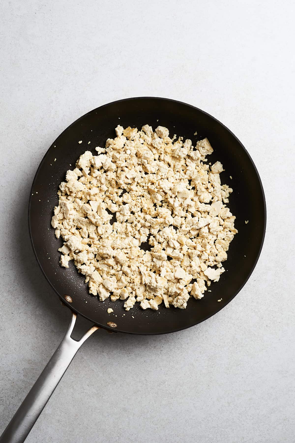 Uncooked tofu in a frying pan.