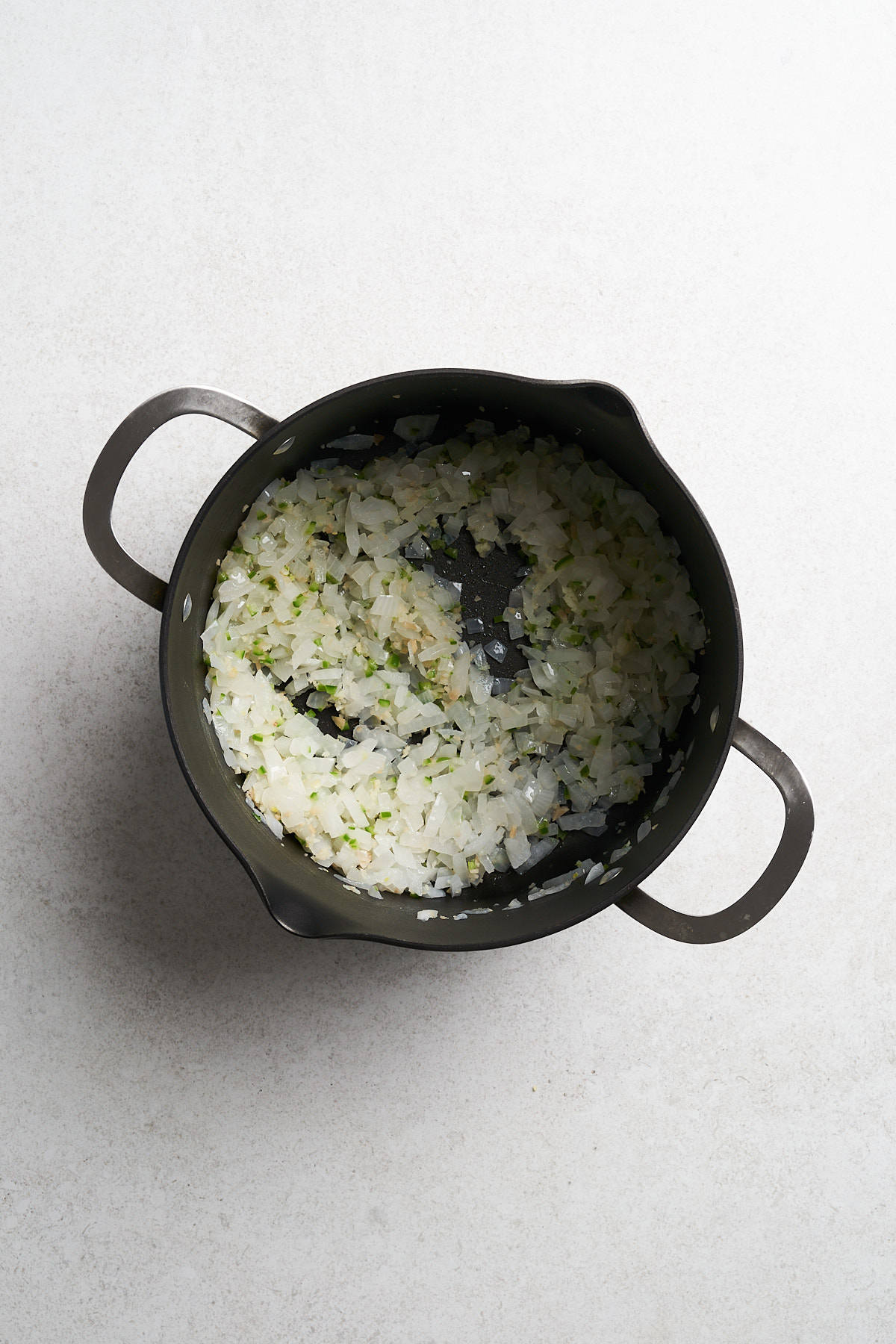 Onions with coconout oil in a pot.